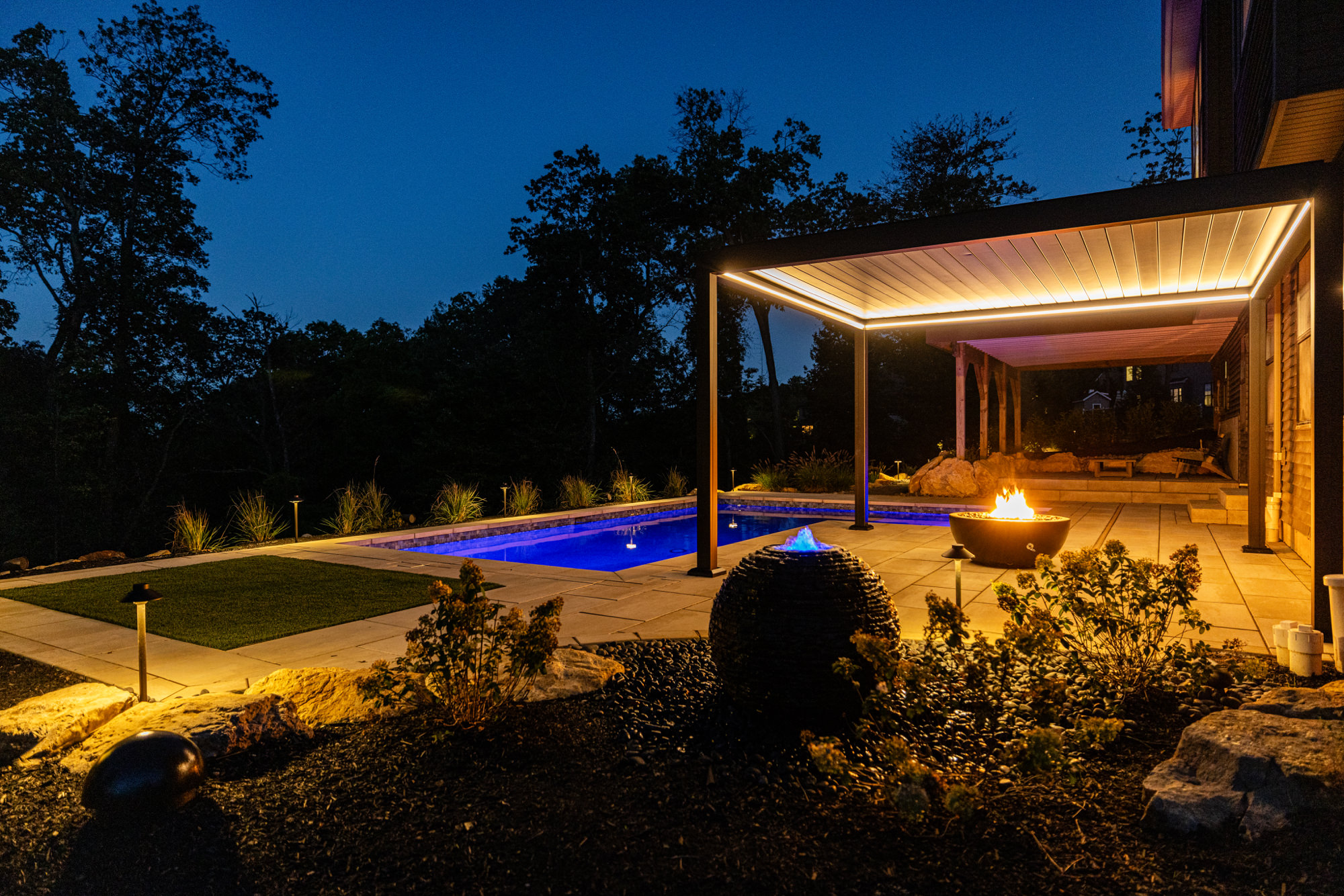 Modern large-format paver patio with pool and pergola
